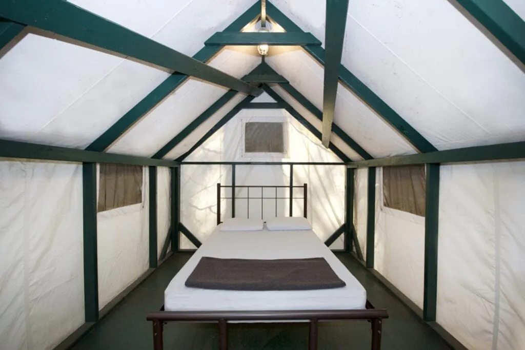 Interior of Curry Village tent cabin in Yosemite showing simple beds and furnishings