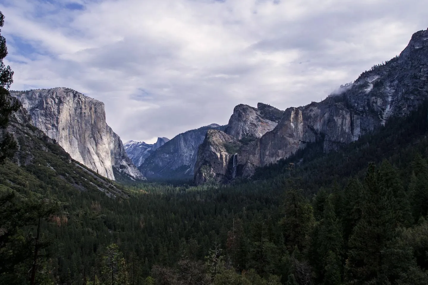 Yosemite Valley camping with stunning granite cliffs and waterfalls in background