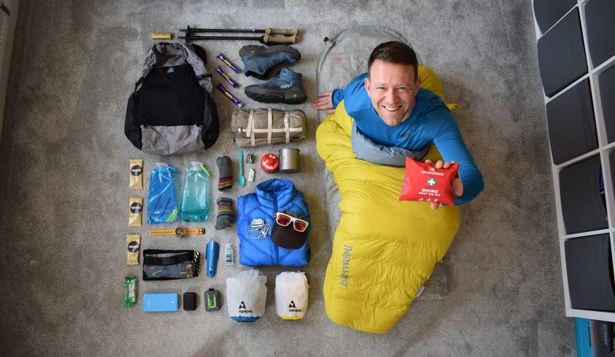Multi-day hiking gear spread out showing essential backpacking equipment