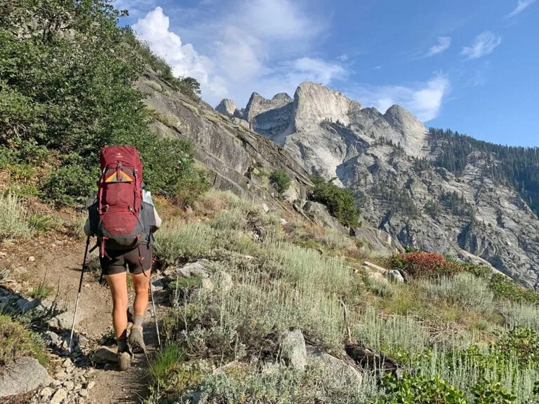 Hiker using navigation tools during multi-day hiking trips in wilderness
