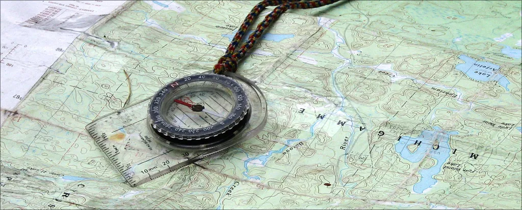 Topographic map with compass showing proper orientation technique