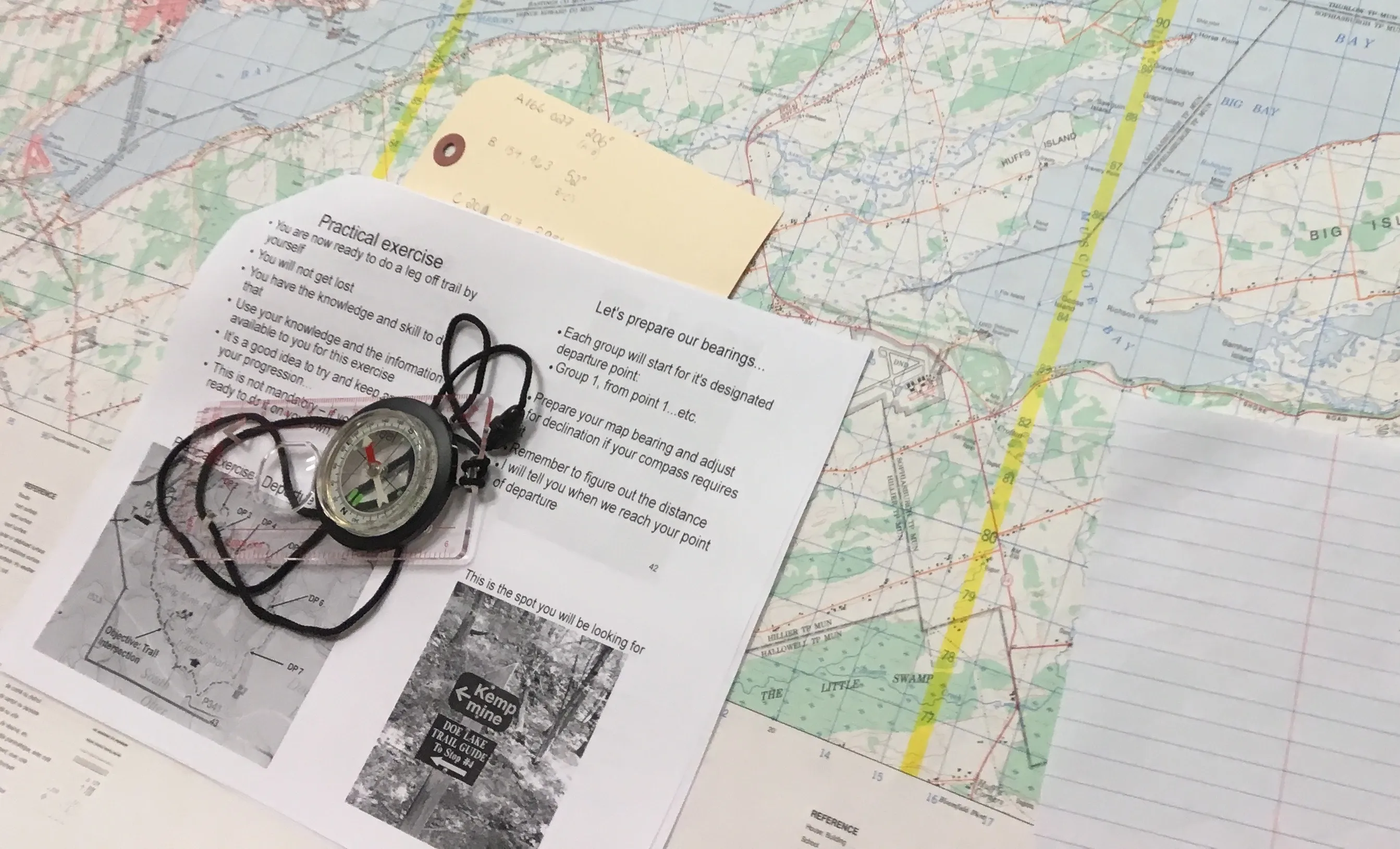 Hiker using map and compass for wilderness navigation