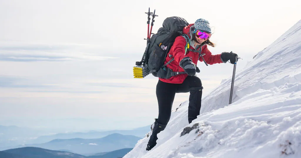 Winter hiking essential gear laid out showing hypothermia prevention equipment