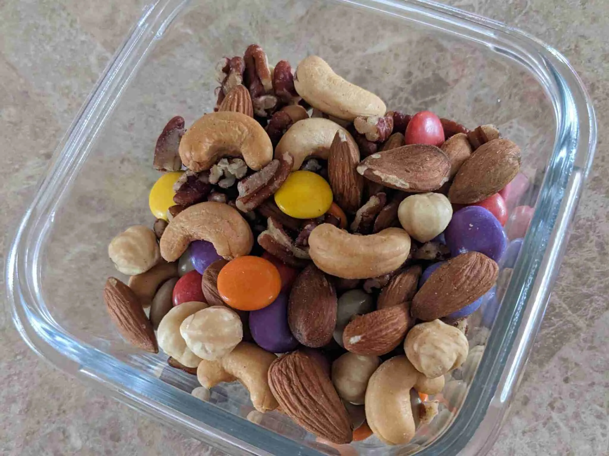 High-energy hiking snacks including protein bars, nuts, and dried fruits arranged for safe trail snacking