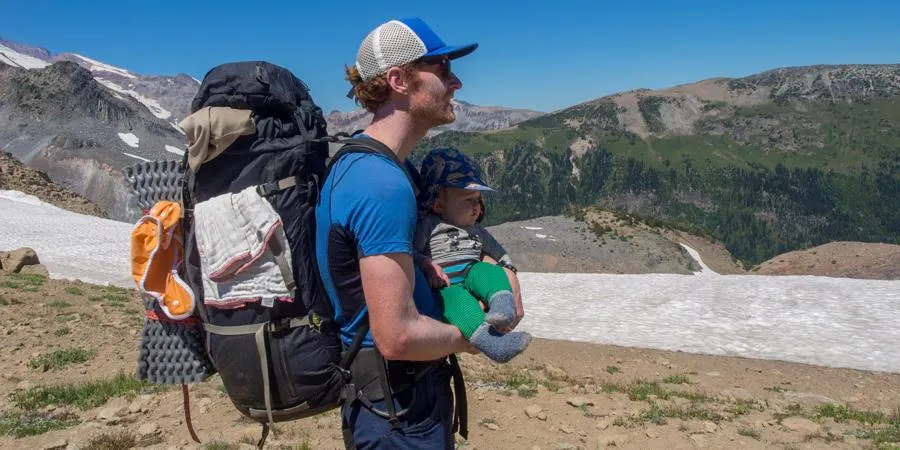 Parent teaching children essential outdoor safety rules on hiking trail