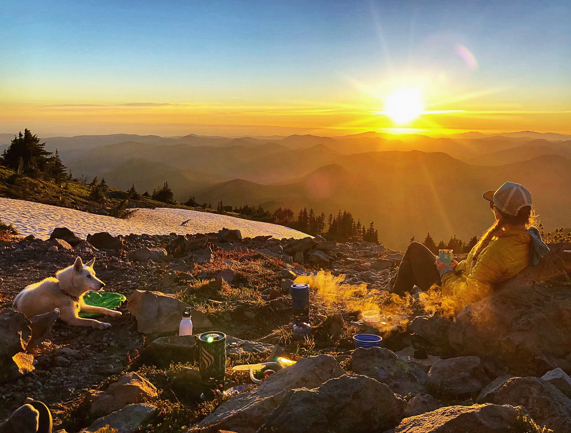 Solo female hiker planning route at sunset for night hiking safety