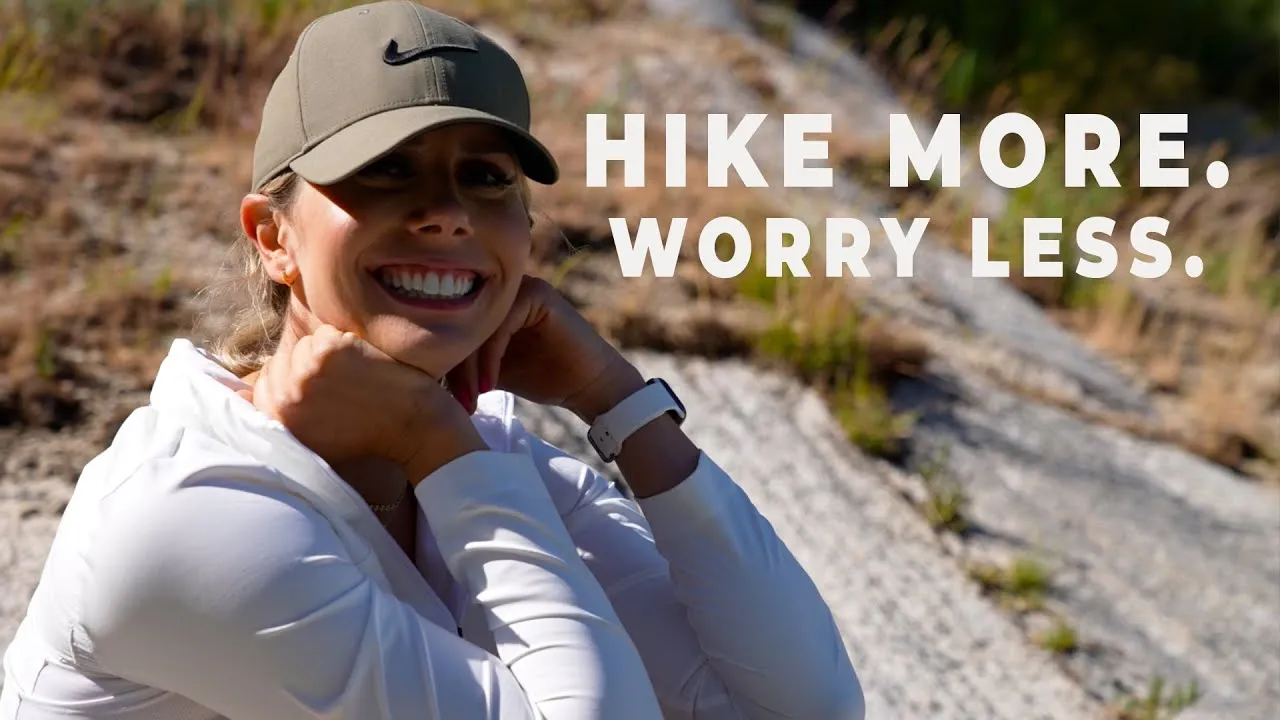 Person experiencing mental wellness benefits while hiking in peaceful forest setting
