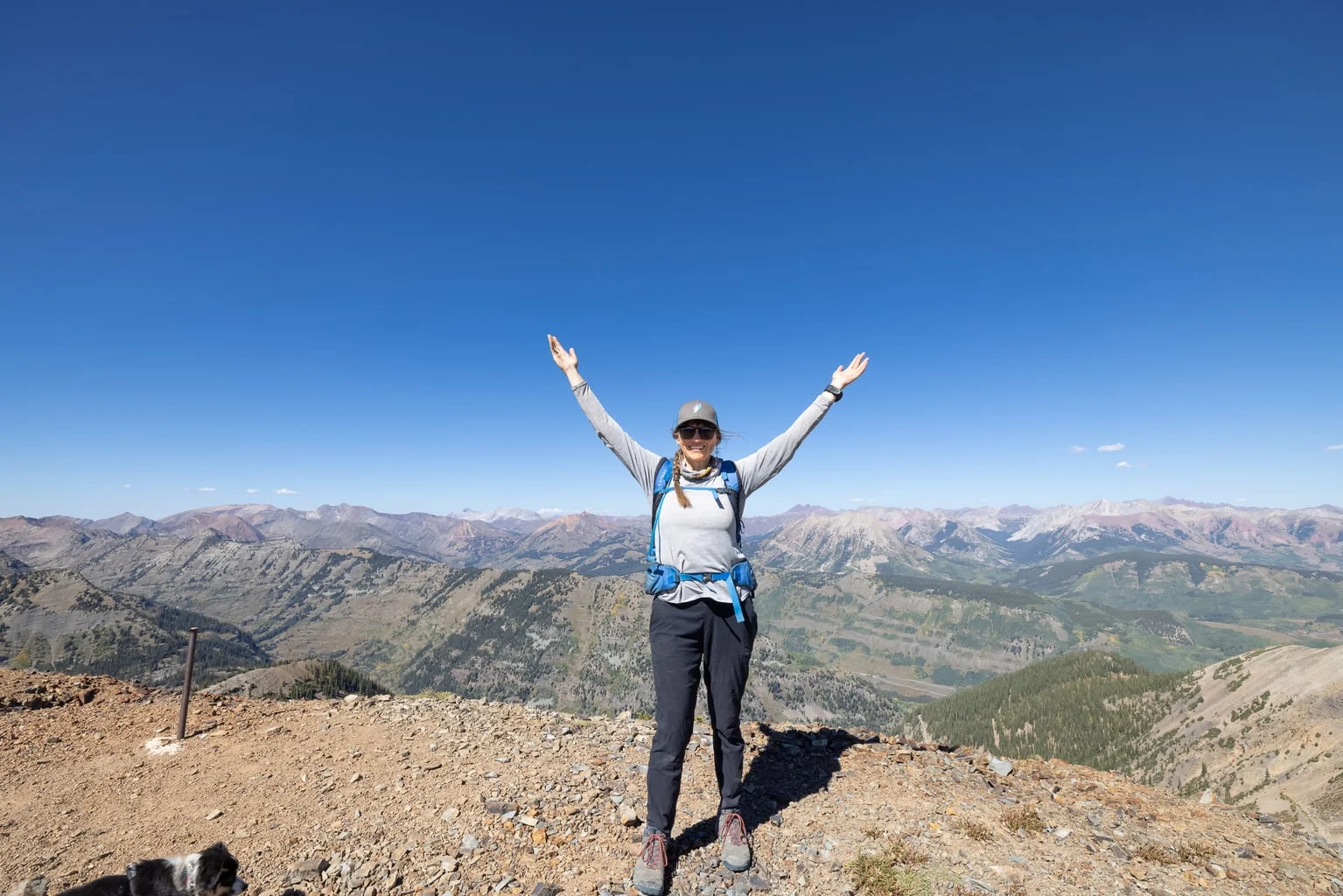 Woman hiker demonstrating proper layering system on mountain trail