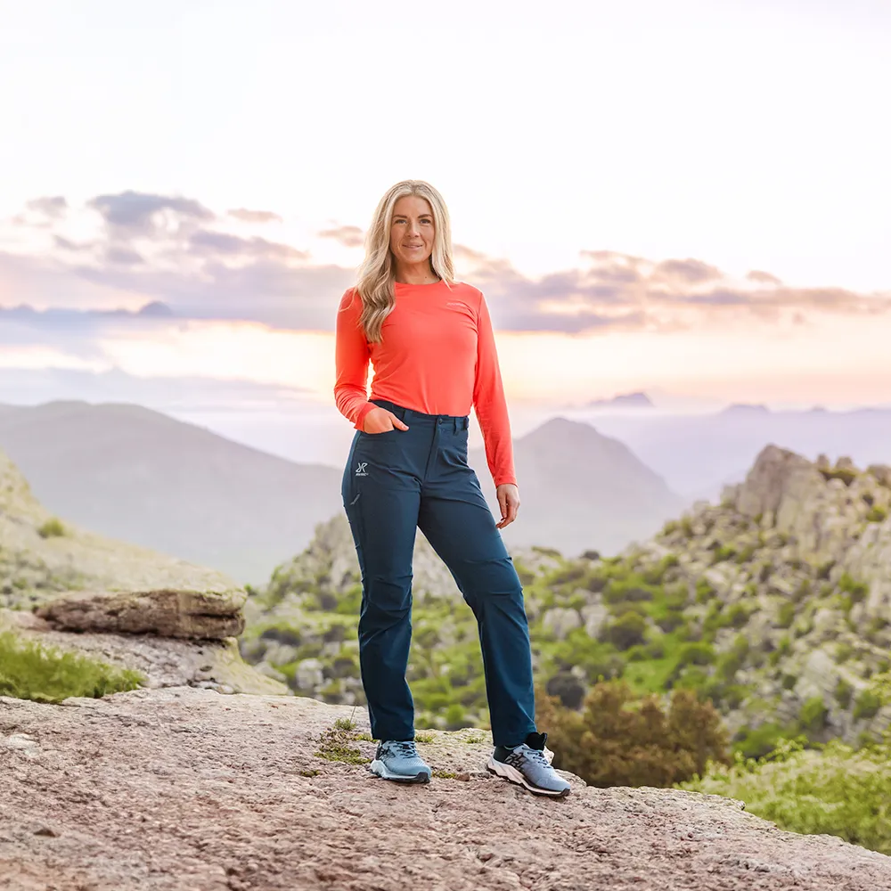 Woman demonstrating proper hiking outfit fit and layering