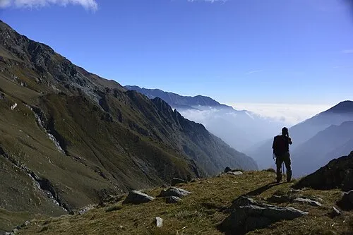 Hiker enjoying mountain views in the Alps demonstrating mental health benefits of hiking