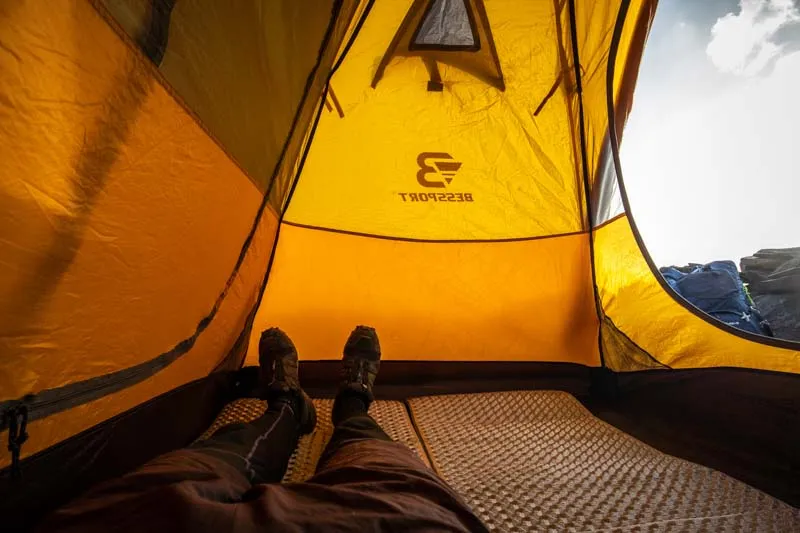 Interior space comparison showing cramped conditions in a 2-person tent with two sleeping bags