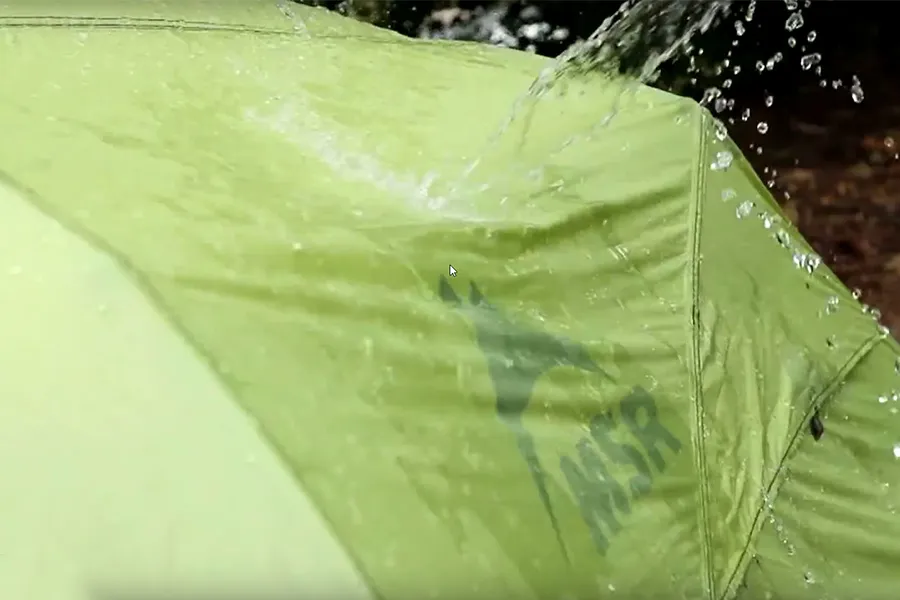 Water splashing off tent surface showing water resistance