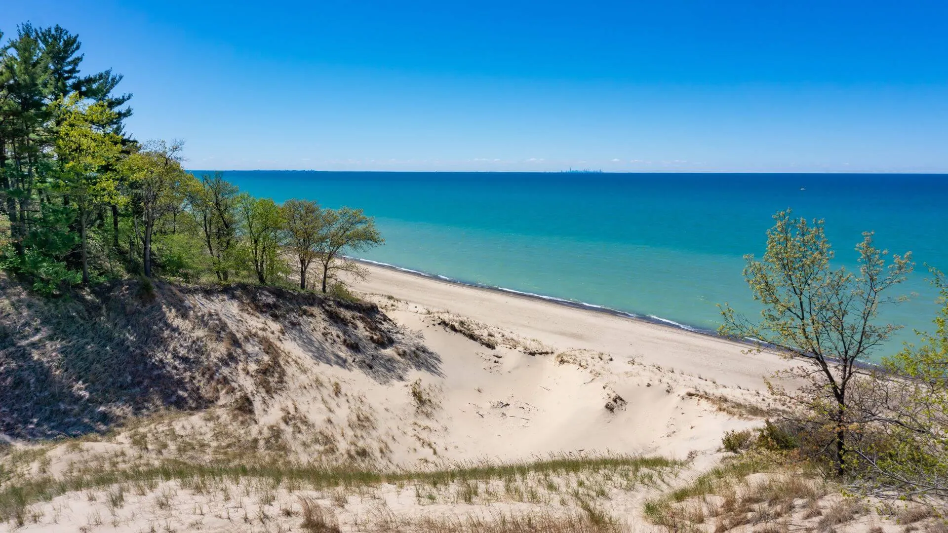 Beautiful sandy beach at Indiana Dunes National Park with clear blue Lake Michigan waters