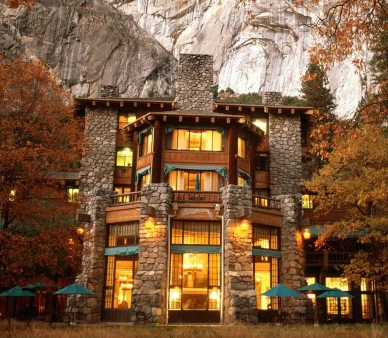 The Ahwahnee Hotel exterior in Yosemite National Park showing the iconic architecture surrounded by towering granite cliffs
