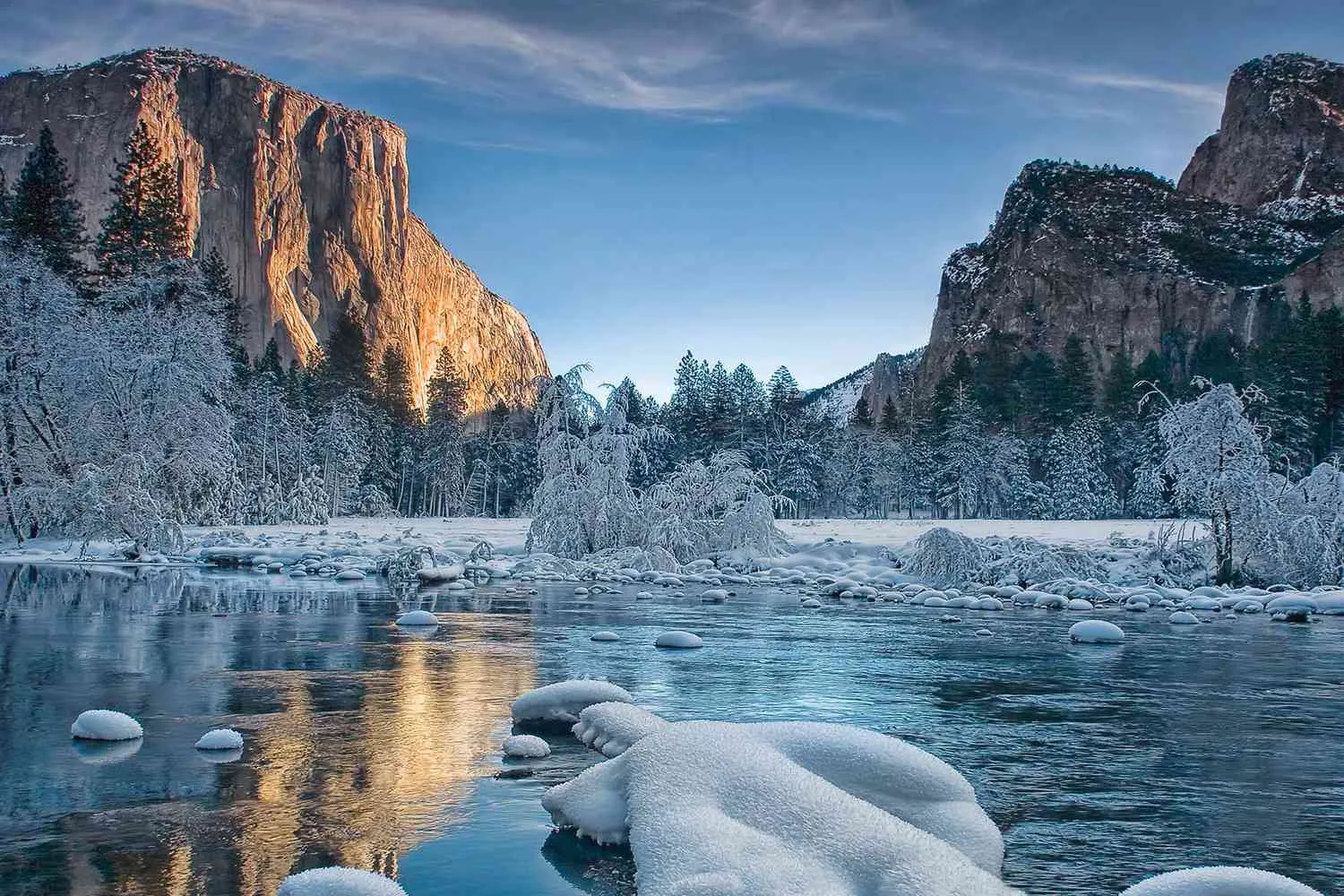 Snow-covered Yosemite landscape with Half Dome and winter trees
