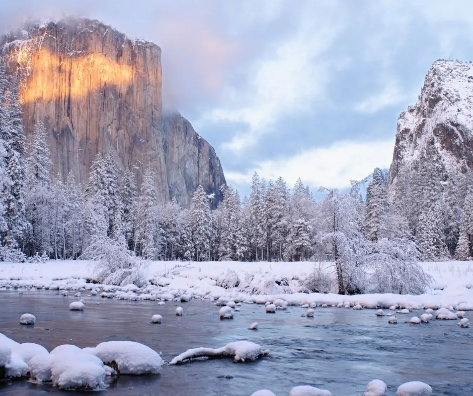 Stunning winter landscape of Yosemite National Park in March showing snow-covered granite cliffs and peaceful valley