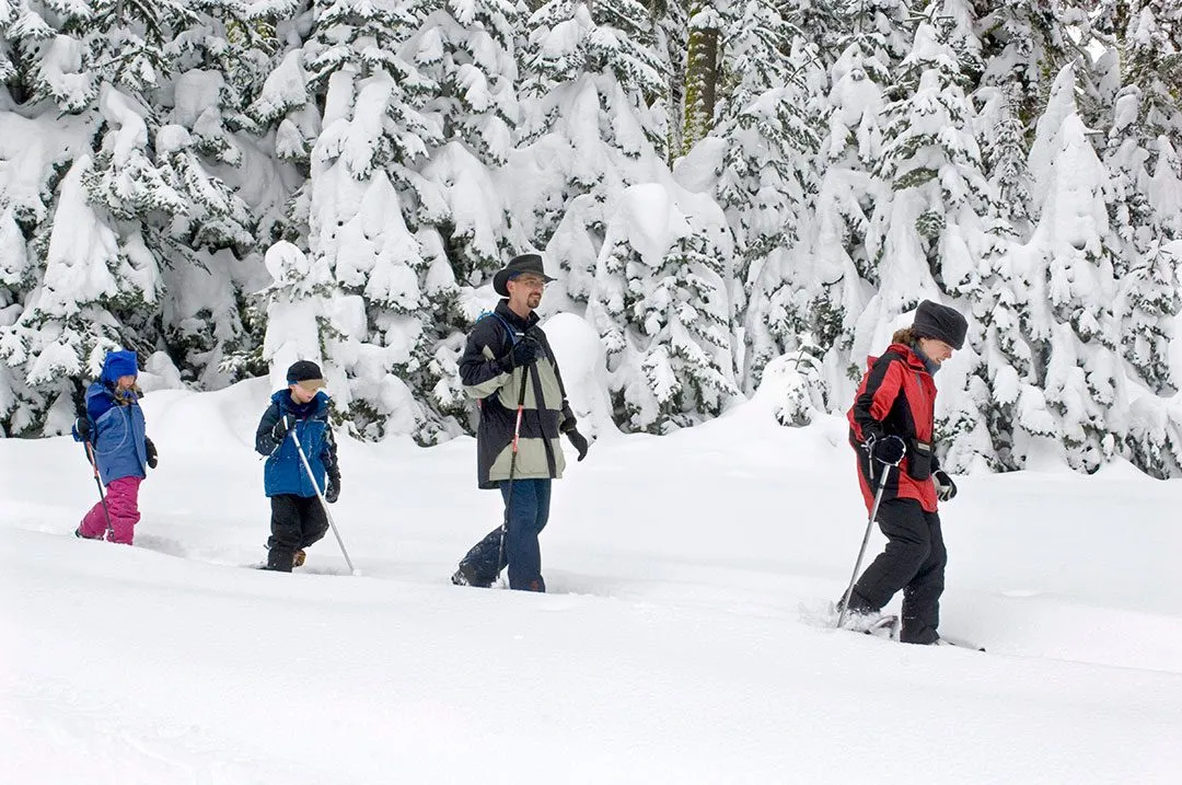 Family snowshoeing through beautiful winter landscape in Yosemite National Park in March