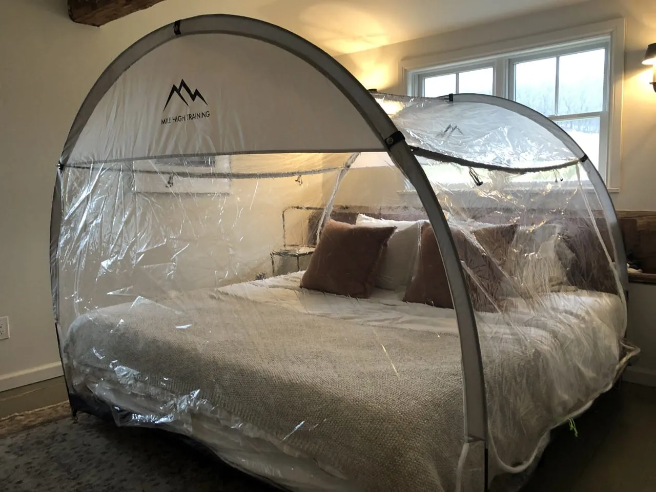Altitude tent setup on bed showing realistic home installation