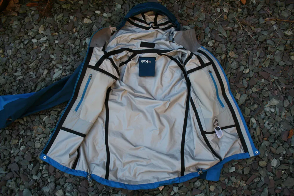 Close-up view of taped seams inside a waterproof jacket showing the sealed stitching lines