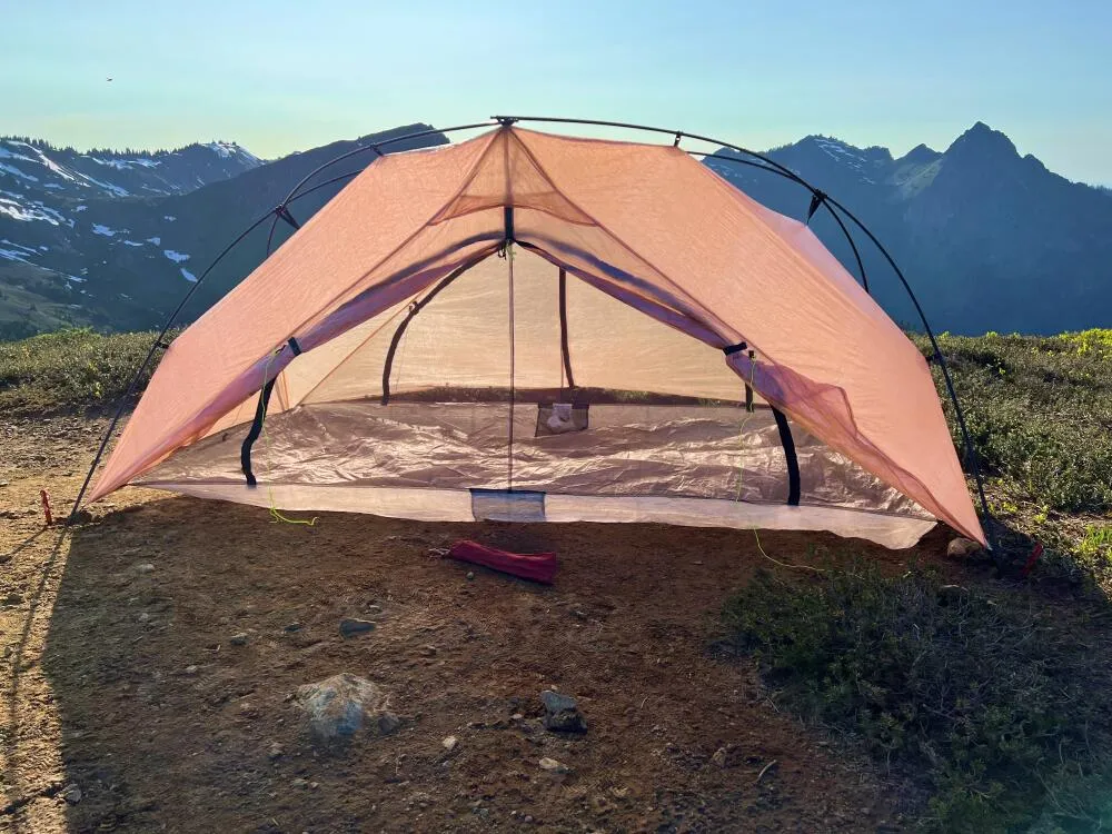 Free Zip 2P tent in alpine environment with mountain backdrop