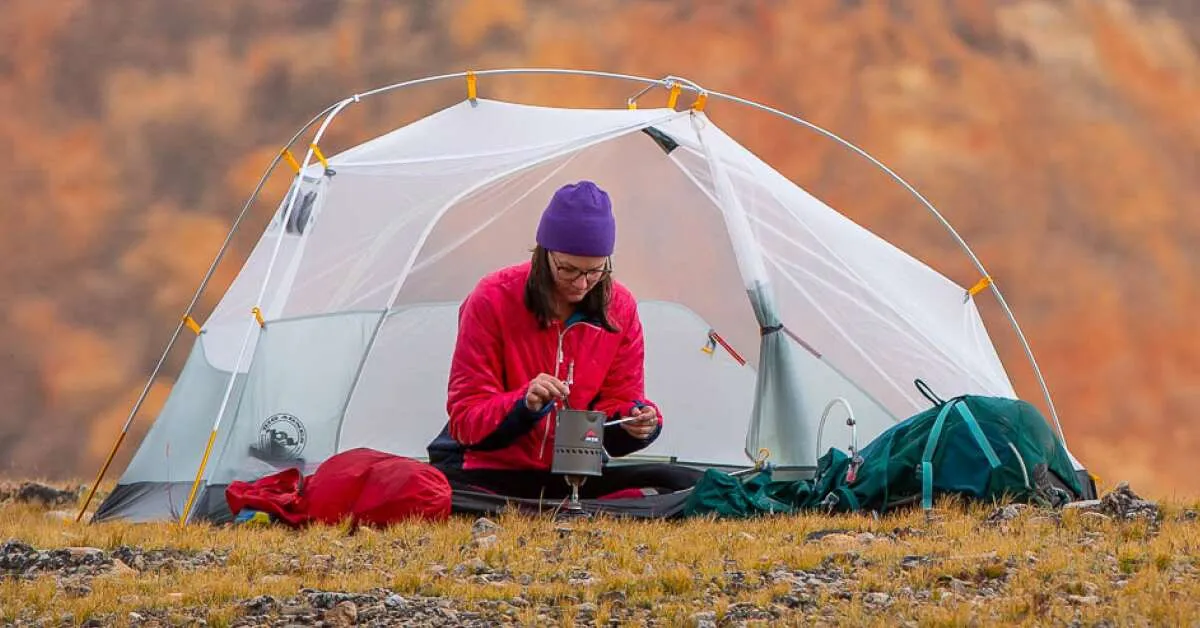 Ultralight freestanding backpacking tent setup in mountains