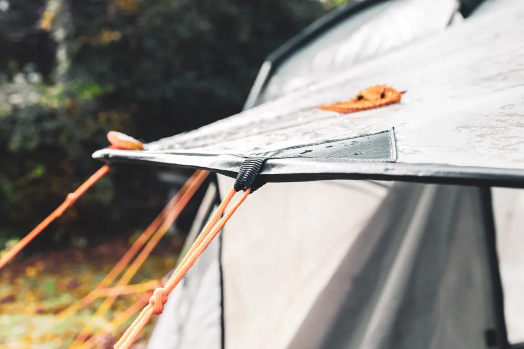 Tent in heavy rain showing waterproof rating comparison