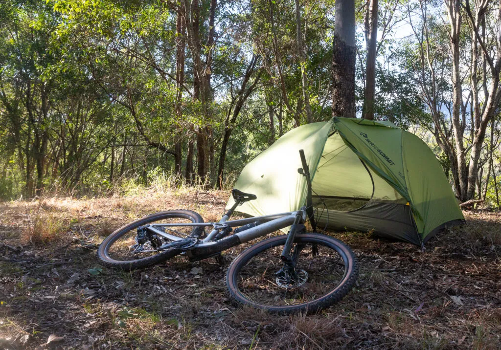 Detailed view of Sea to Summit Telos TR2 bikepacking tent components including poles, rainfly, and storage bags