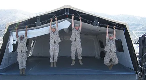 Military tactical tent in desert environment showing camouflage integration and field deployment