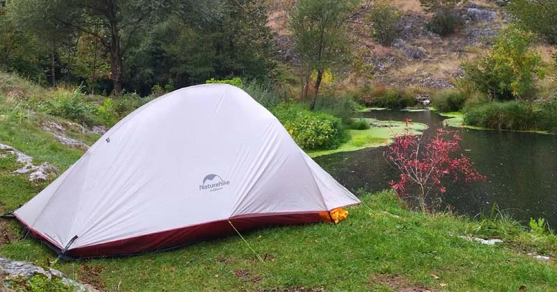 Naturehike tent setup in outdoor camping environment