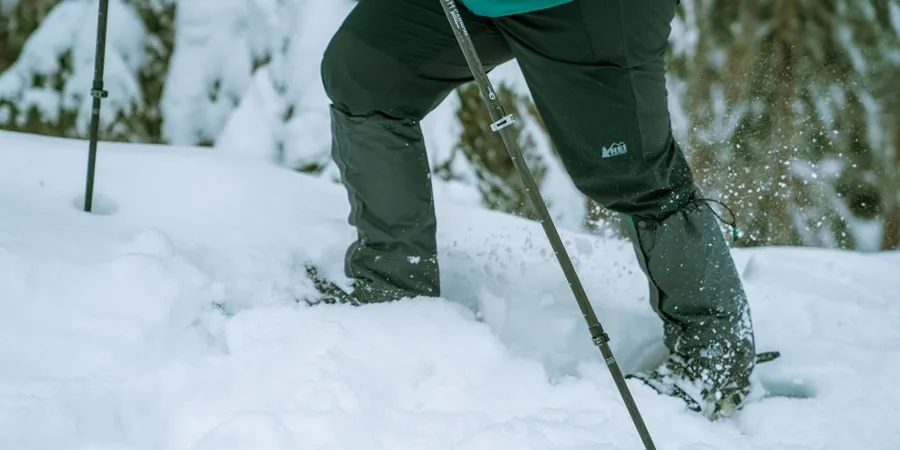 Different types of hiking gaiters displayed showing ankle, mid-calf, and full-length options for various outdoor activities