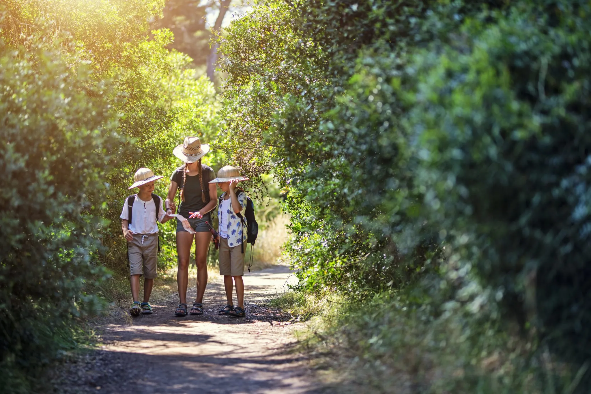 Parents hiking with toddlers and young children on a nature trail