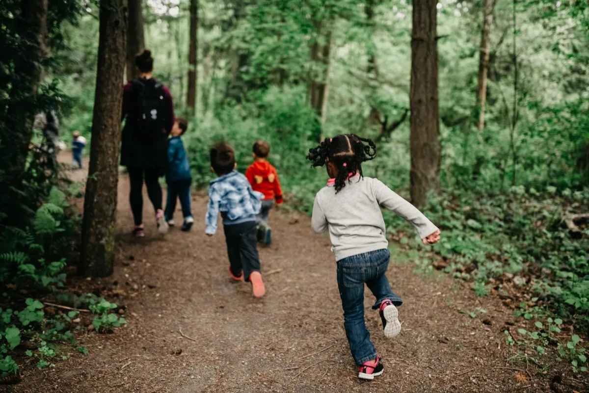Parent and child hiking together with safety gear, showing proper family hiking preparation